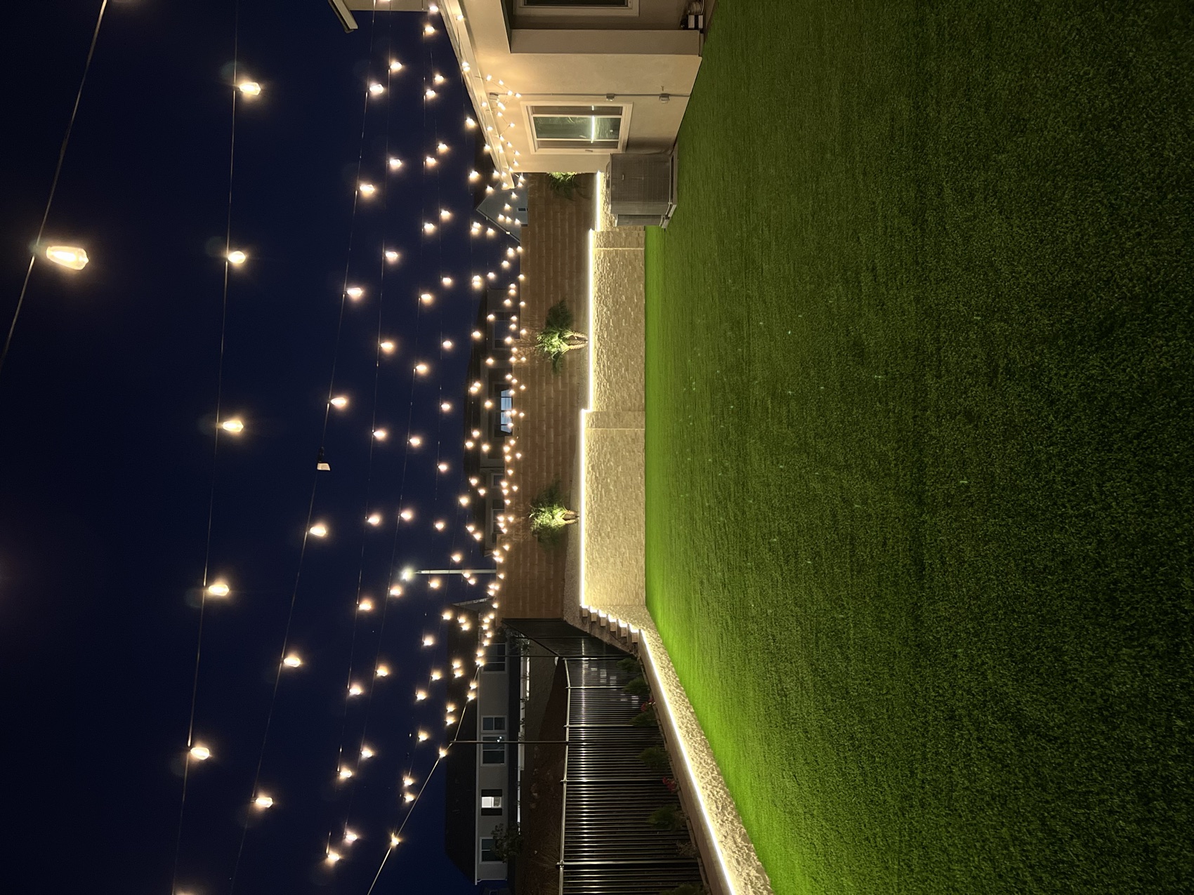 String-lit turf yard in the evening