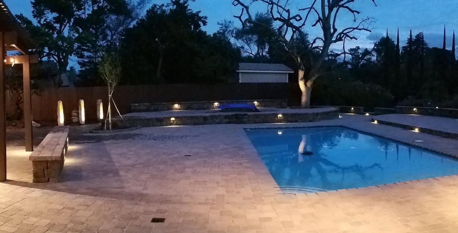 Paver pool deck at dusk, Riverside [sample]