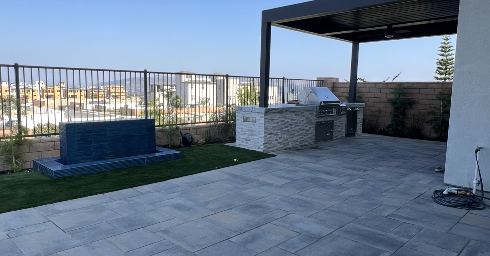 Outdoor kitchen & water feature with city view