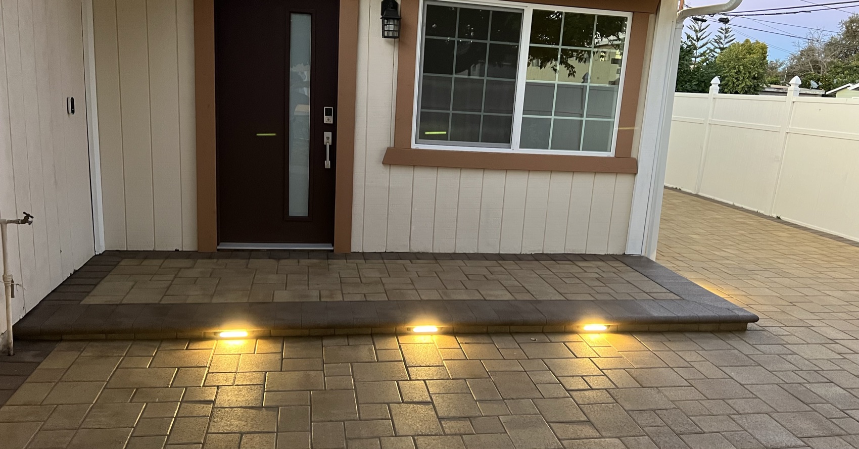Lit entry steps & paver landing at dusk